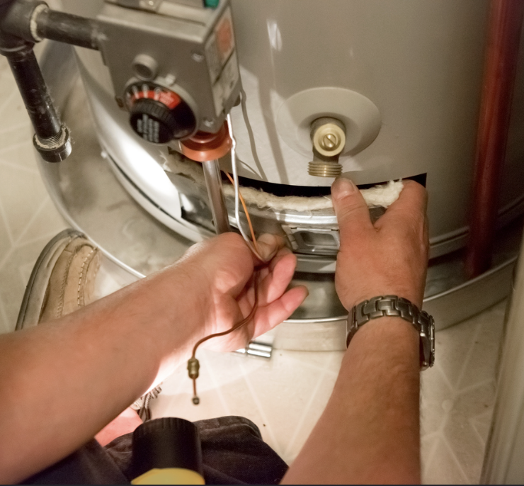 Technician repairing a water heater
